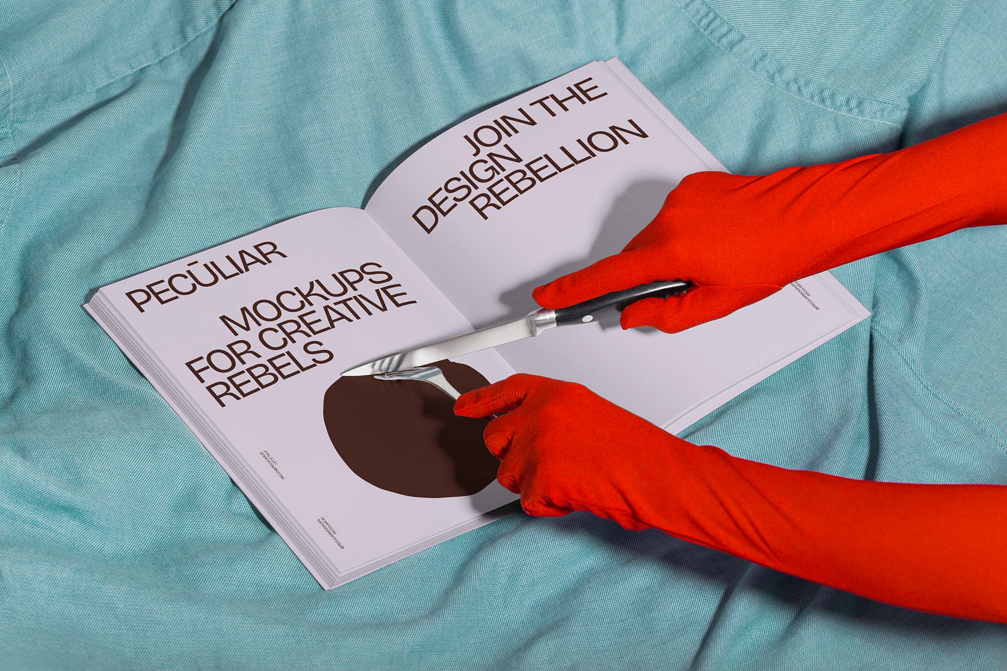 Two gloved hands holding utensils over an open book mockup set against light blue fabric, in use example alternative colors.