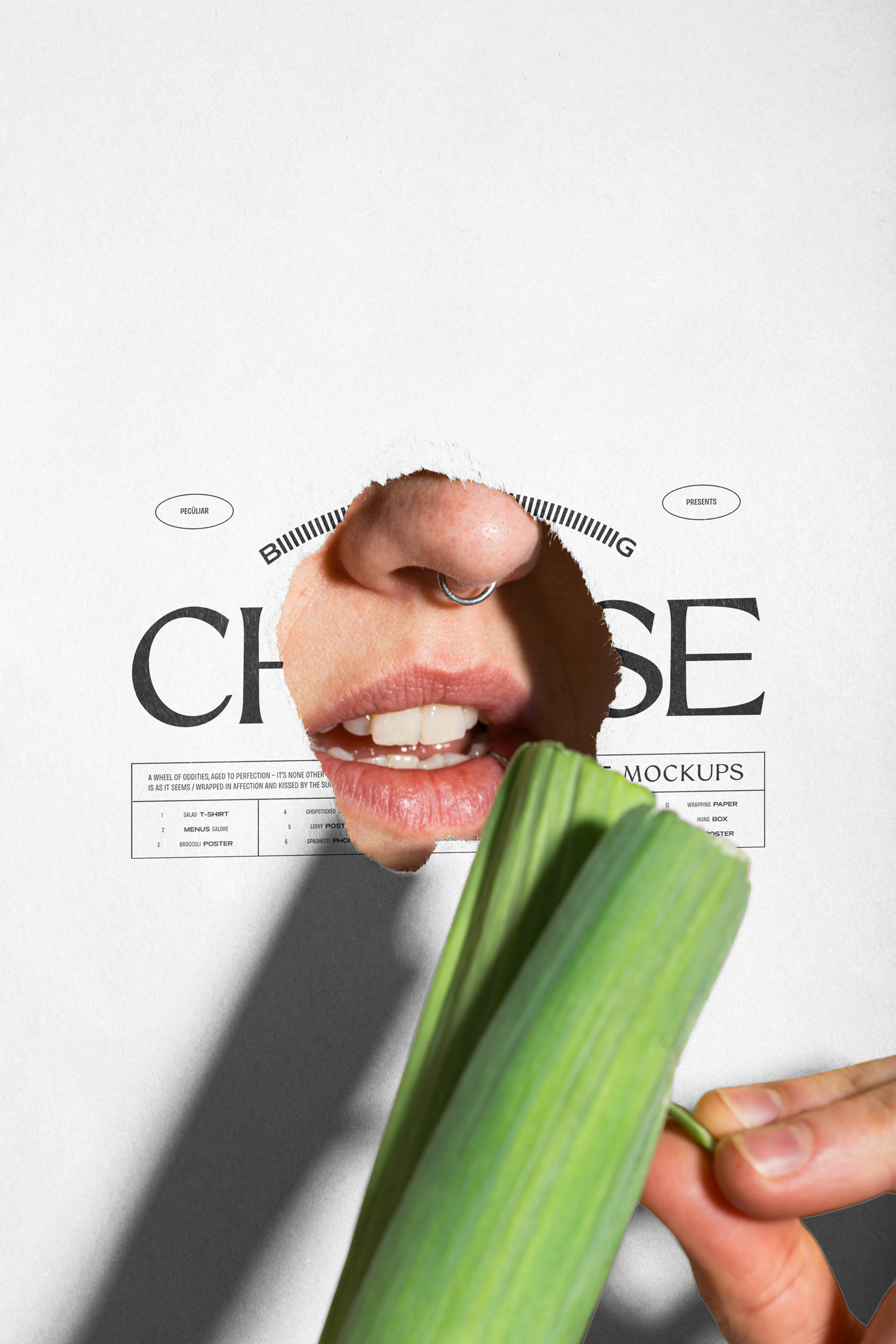 Close-up photo of a torn poster mockup with black typographic print placed on top of a person's mouth while they're peeling a raw leek, in use example.
