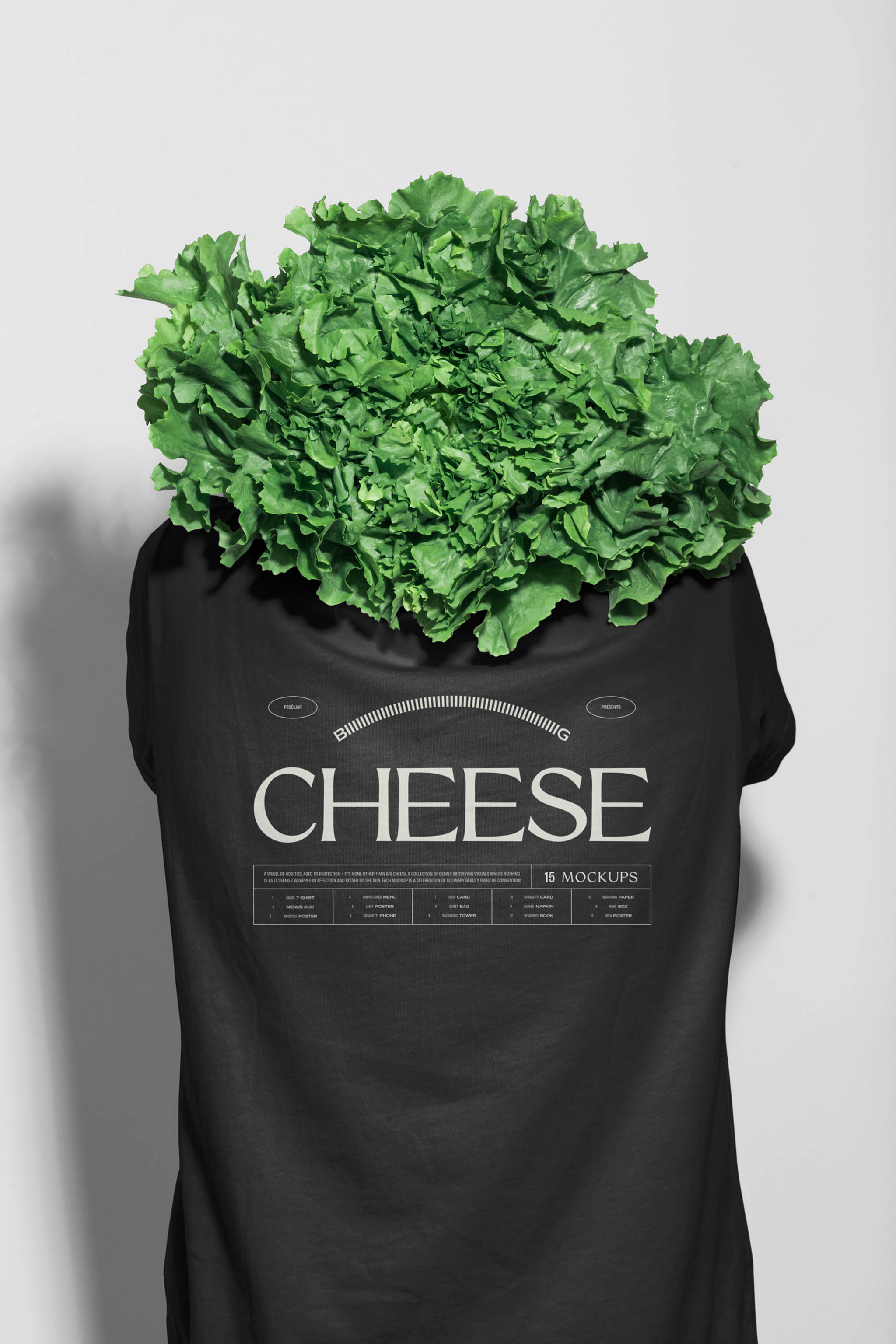 Photo of a person's back wearing a white minimal cotton t-shirt mockup with central black typographic design and a salad head, in use example alternative colors.